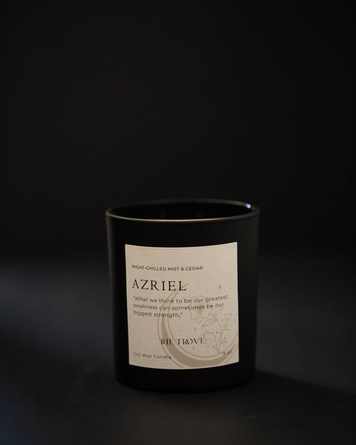 Black candle with a label on a dark background