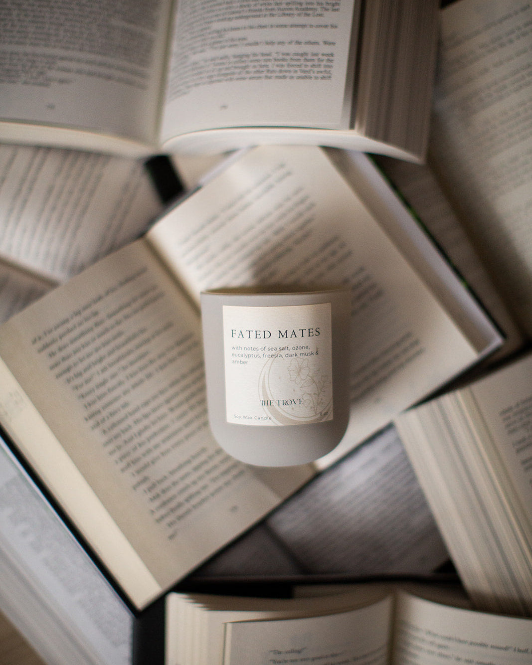 Candle labeled 'Fated Mates' on top of open books