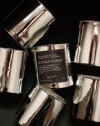 Silver cylindrical containers with a central label on a dark background
