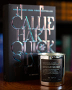 Candle labeled 'Kingfisher' with a book titled 'Call Me Charley' in the background.