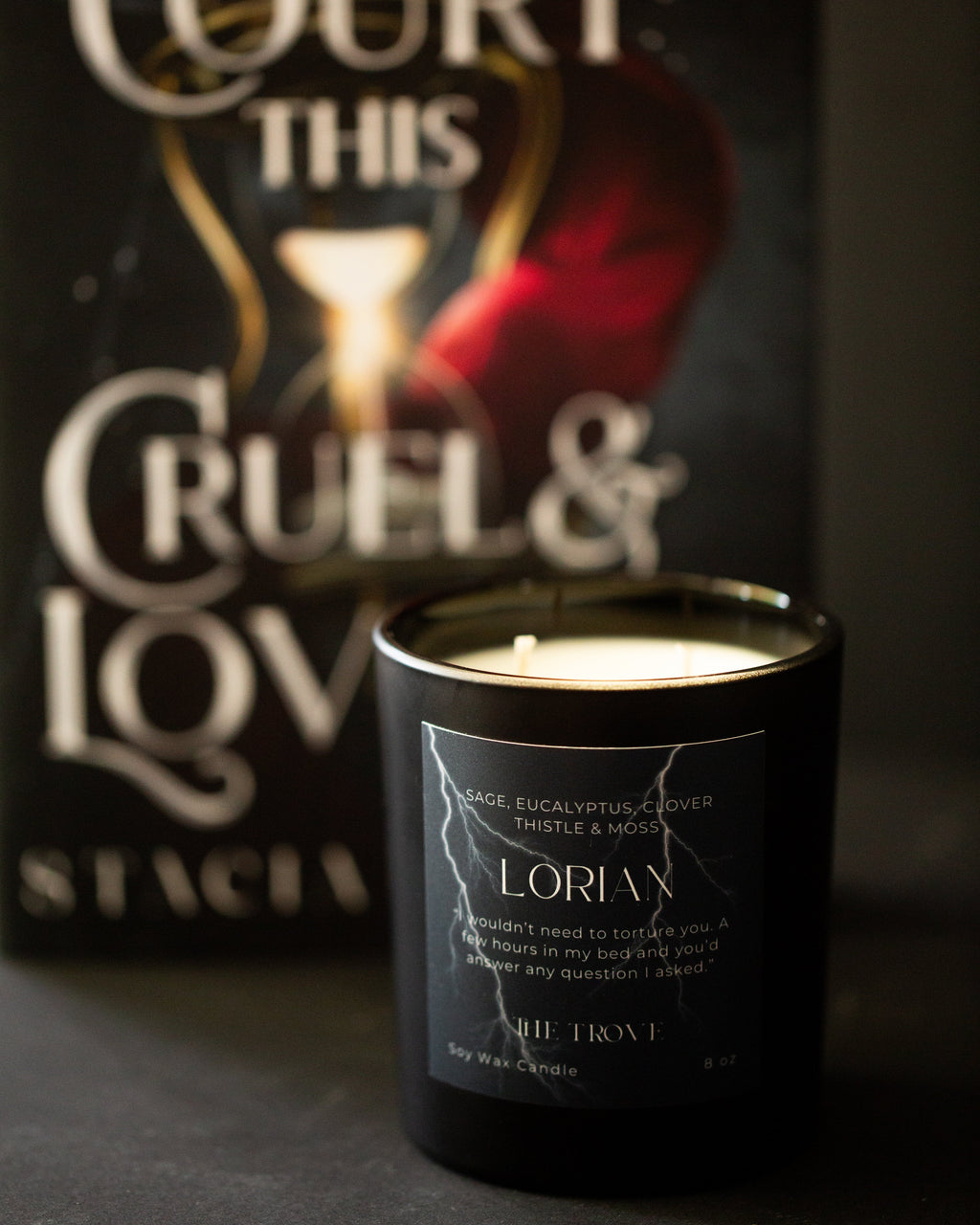 Candle with 'A Court This Cruel & Lov' packaging in the background