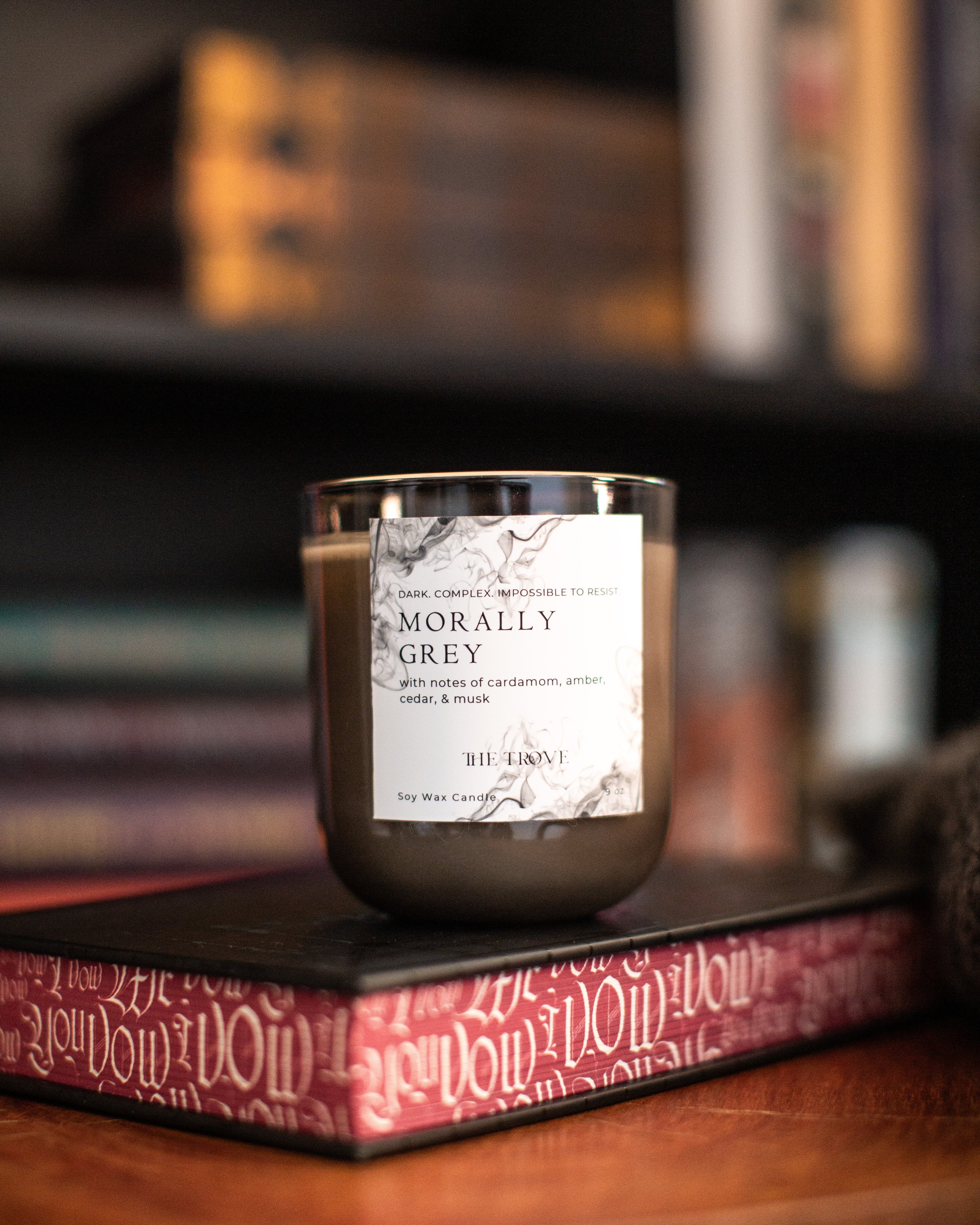 Candle with a label on a bookshelf