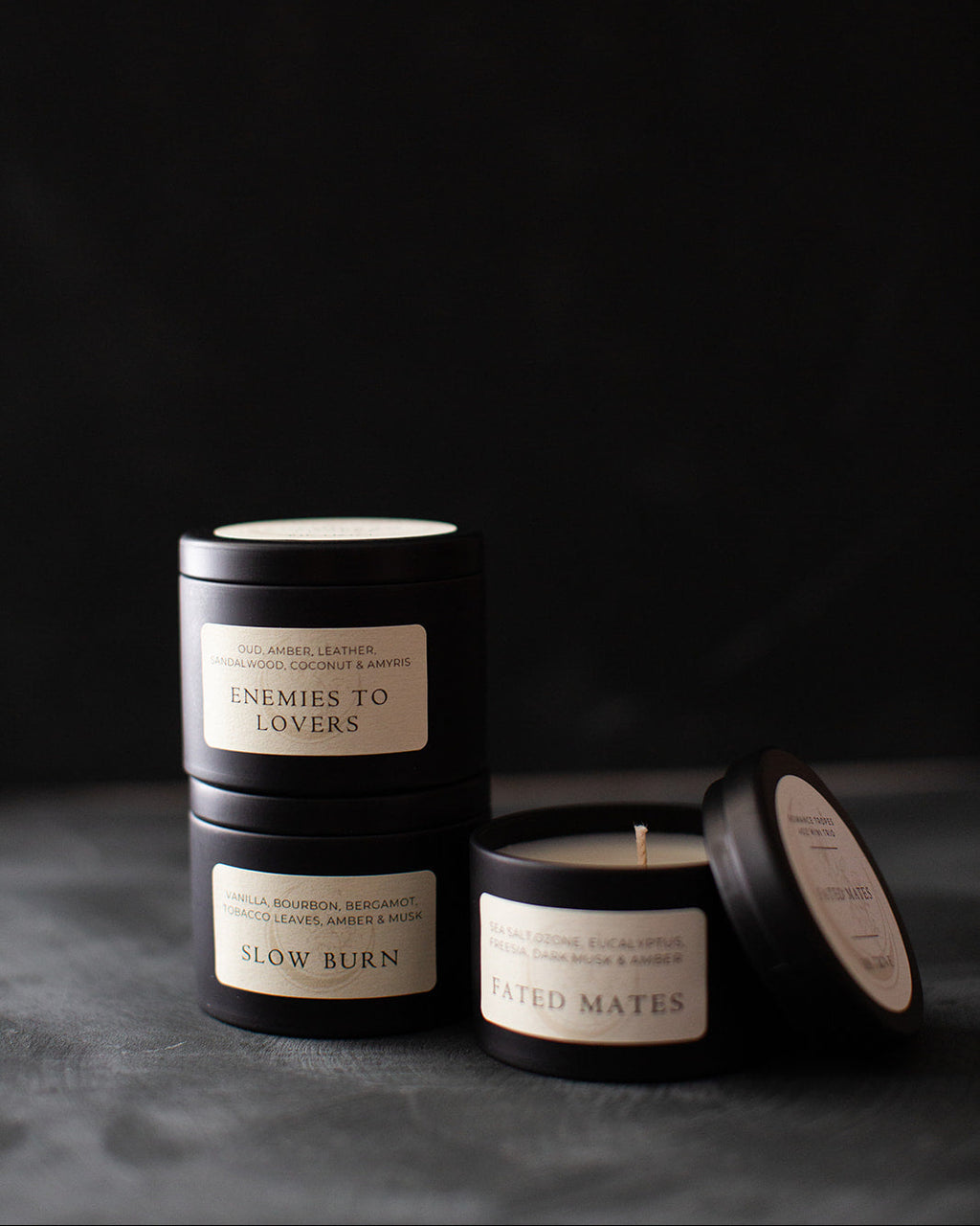 Black candles with labels on a dark background