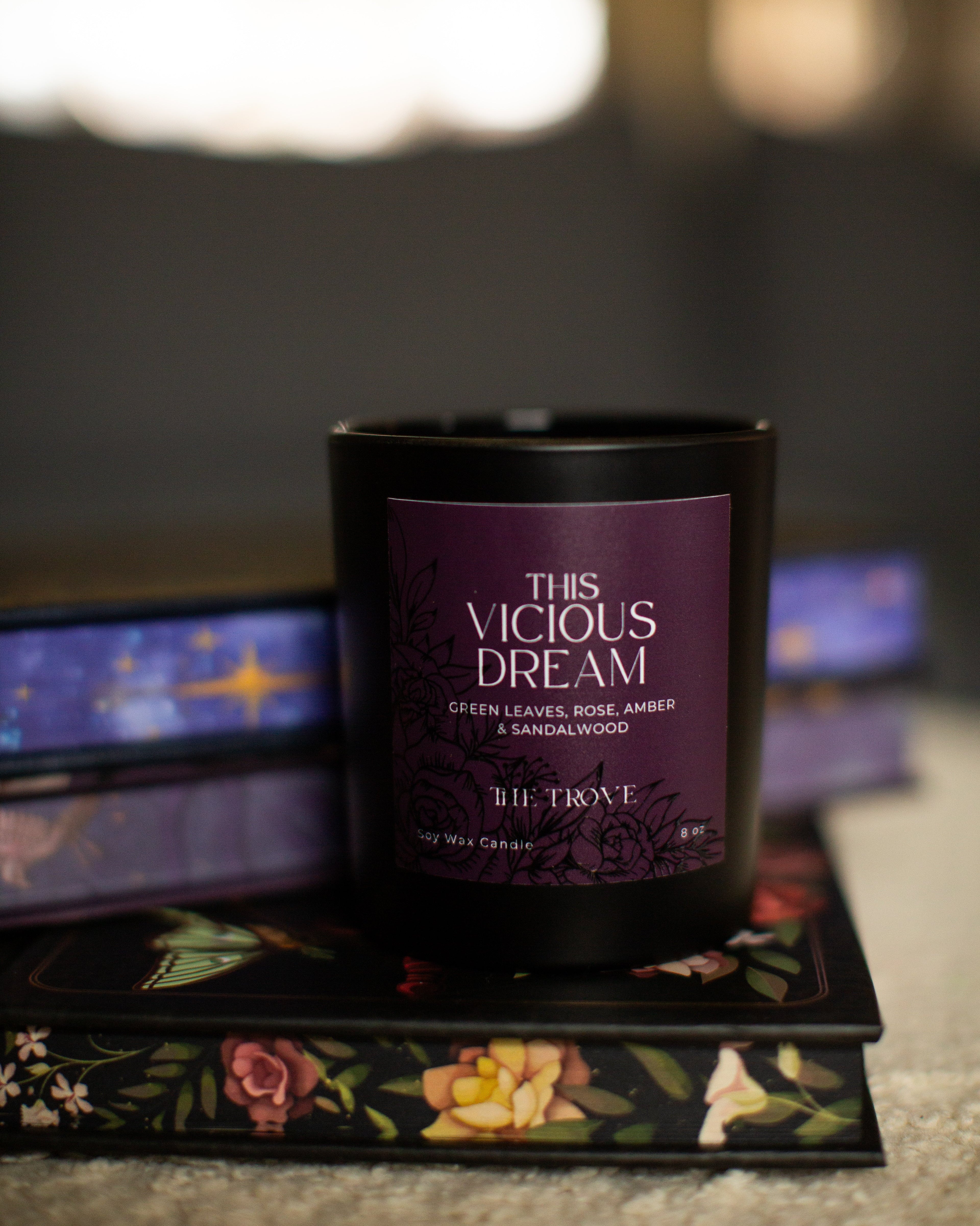 Candle labeled 'This Vicious Dream' by Biltmore on a decorative tray with a blurred background