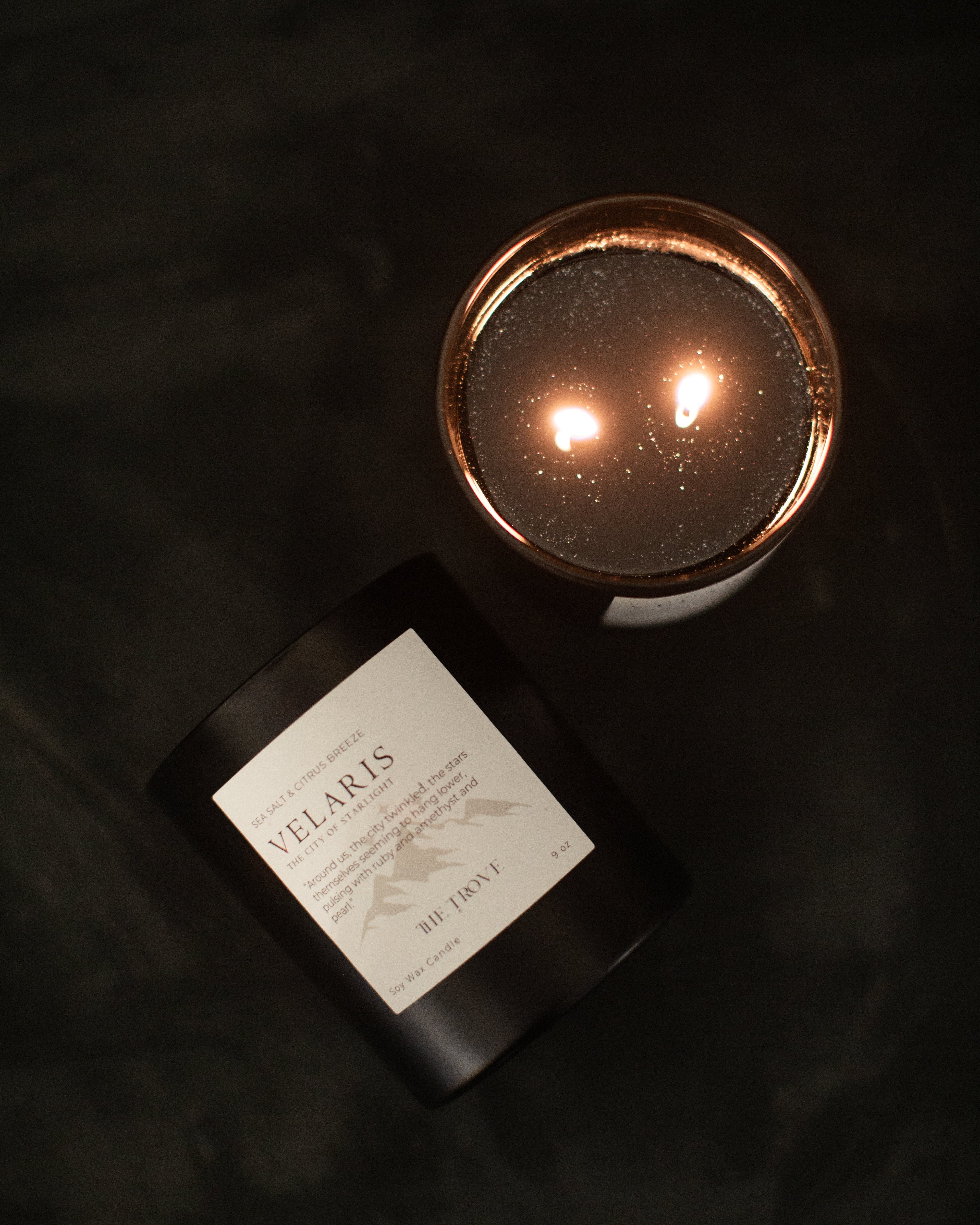 Velaris candle with a label on a dark background