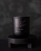 Black candle labeled 'VIOLET' on a dark background