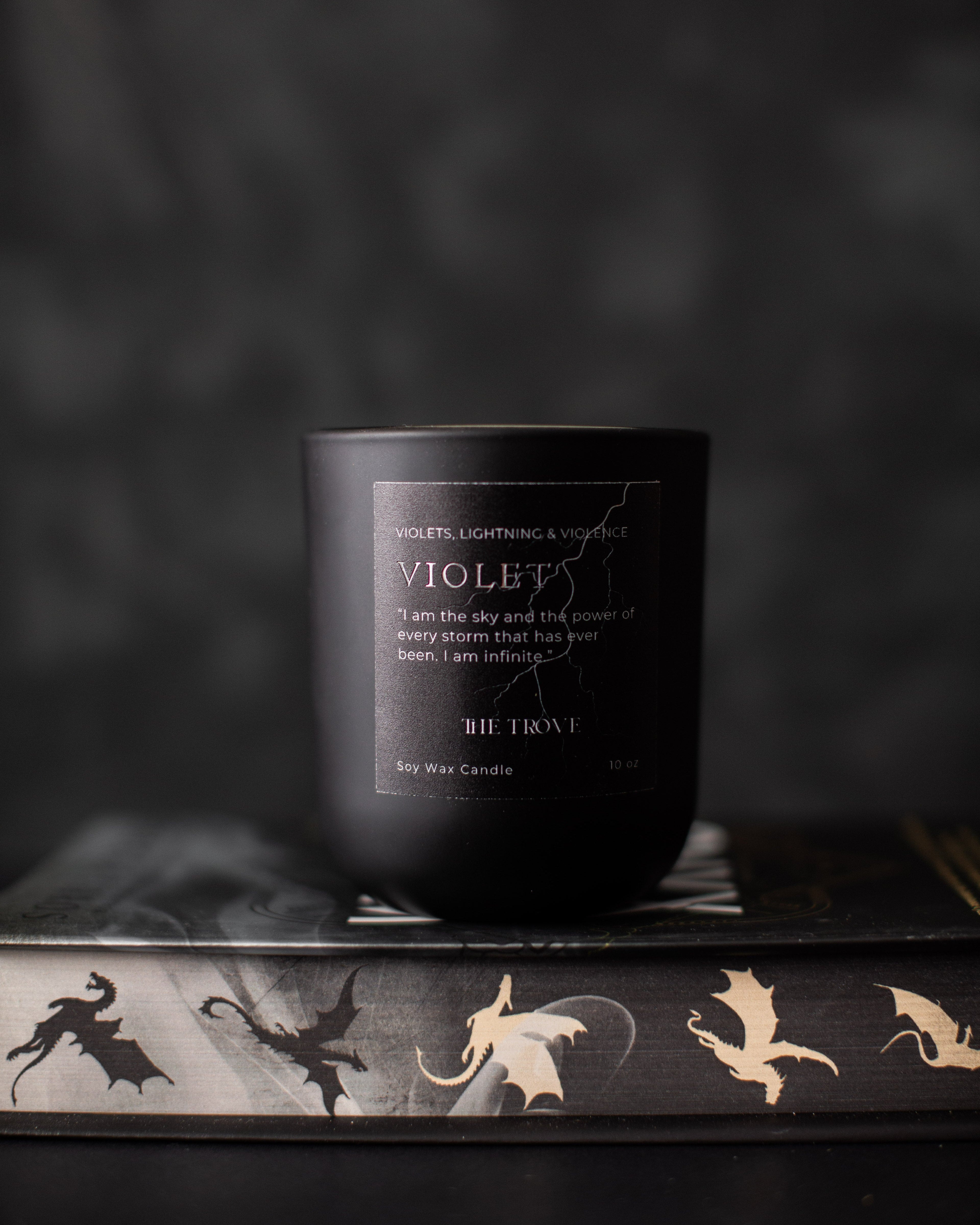 Black candle with a label on a dark background