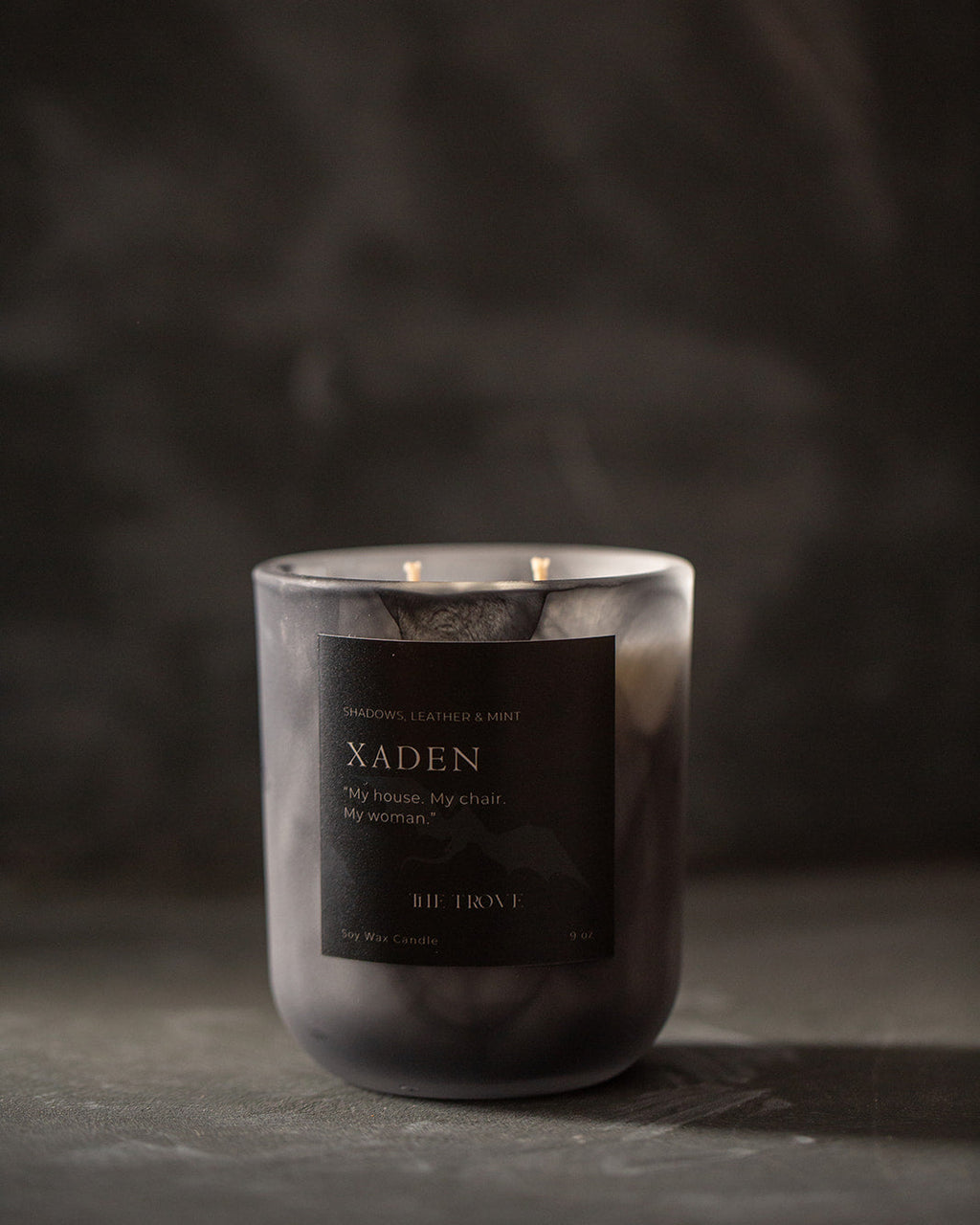 Candle with a dark label on a dark background