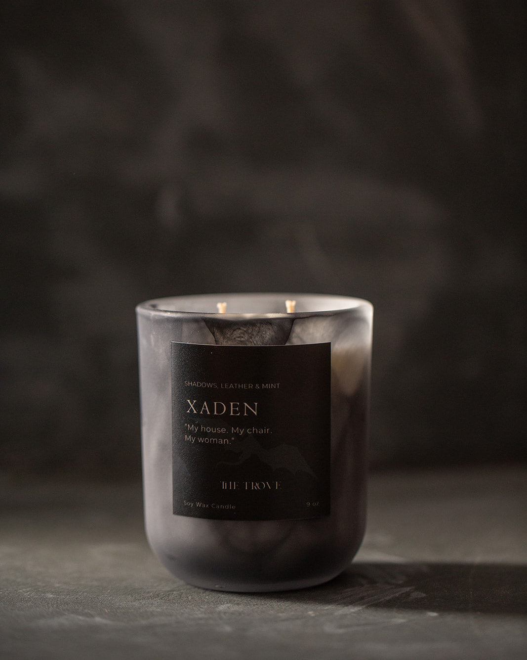 Candle with a dark label on a dark background