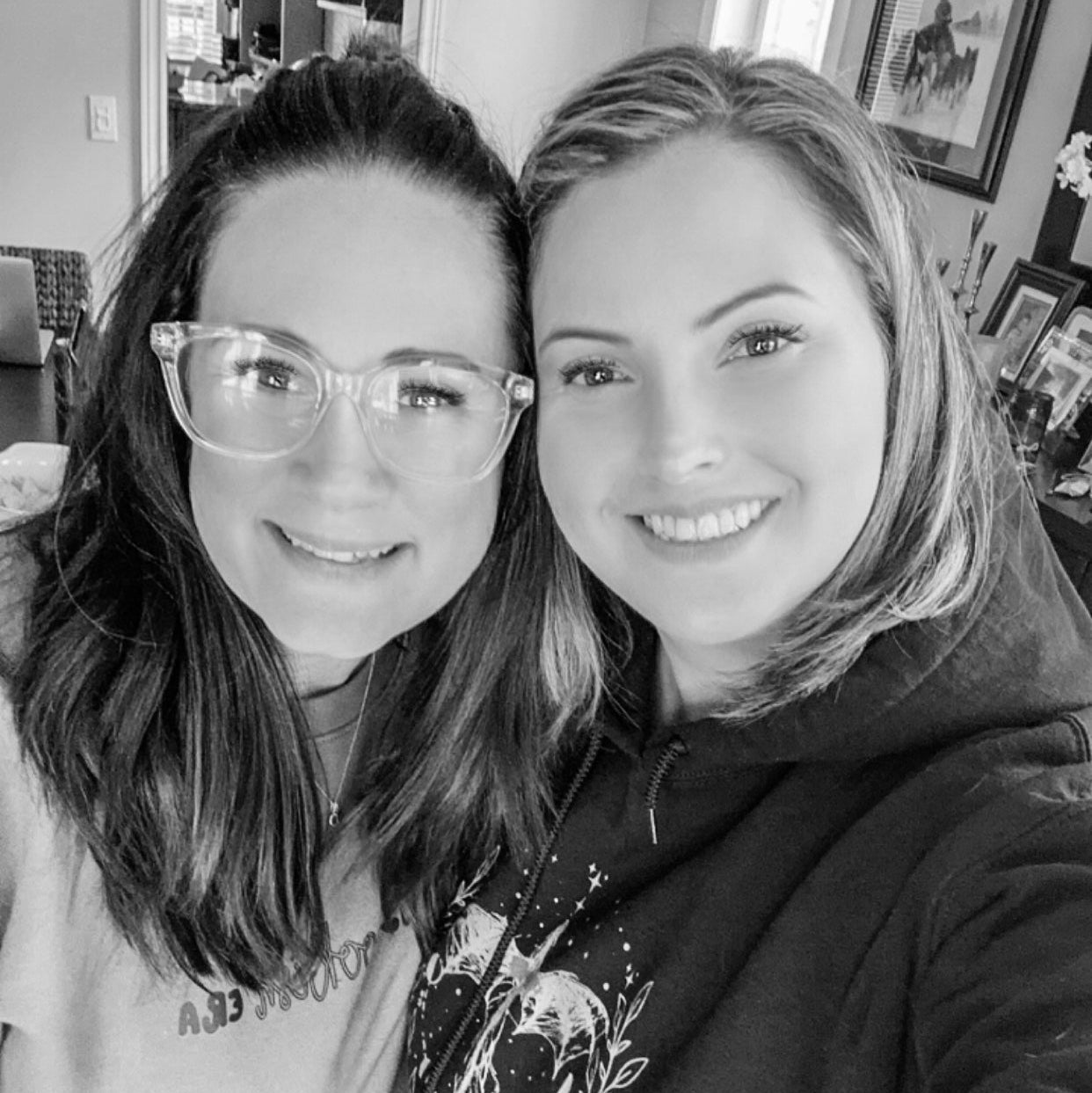 Two women posing for a selfie indoors, wearing casual clothing.
