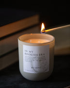 Candle labeled 'In My Bookish Era' being lit with a dark background